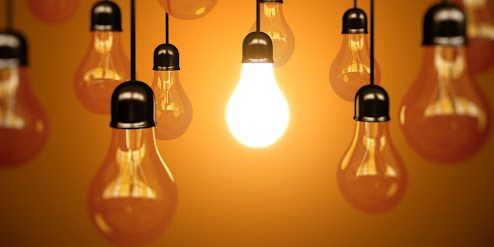 idea concept with light bulbs on a orange background